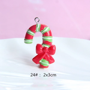 Detailed view of candy cane resin pendant with red bow and metal loop, 2x3cm size