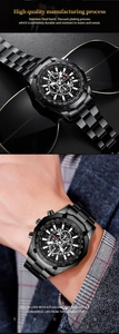Black stainless steel quartz watch with three dials and luminous hands on male wrist