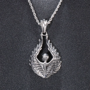 Macro shot of silver titanium steel angel wings pendant with a twisted chain on black background