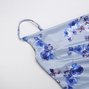 Close-up of floral satin dress showing thin shoulder straps and high-quality sewing detail