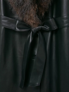 Detail of black leather coat featuring faux fur collar and adjustable waist belt bow