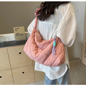 Detail of pink quilted tote bag showing large capacity and quilted fabric texture