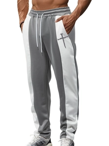 Detail of men's gray and white spliced jogging pants with a cross logo on the pocket