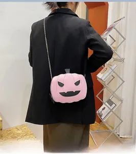 Detailed back view of model wearing pink sequined pumpkin crossbody bag with gold chain