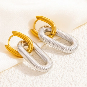 Minimalist round stud earrings with gold and silver two-tone textured metal finish