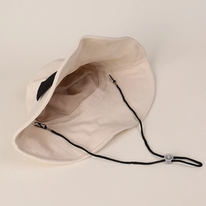 Off-white cotton linen sun hat with bow, wide brim and adjustable black chin strap