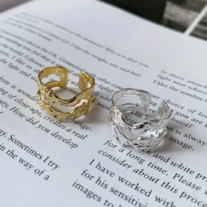 Detail of irregular textured double-layer adjustable S925 silver rings on a magazine
