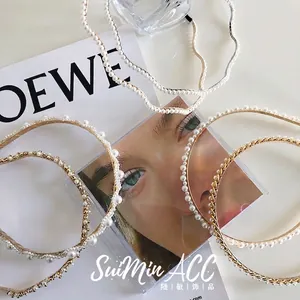 Elegant set of pearl and rhinestone metal headbands in gold finish and wavy designs