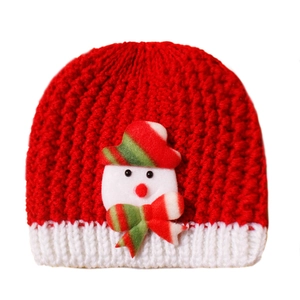 Detail of red Christmas knit baby hat featuring white trim and a cute snowman patch