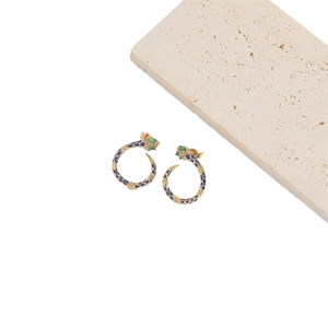 Vintage golden snake hoop earrings with blue enamel patterns and green gem eyes