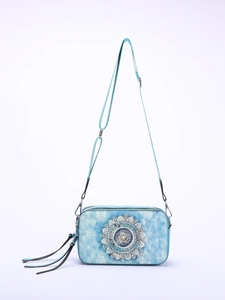 Detail of blue rectangular crossbody bag featuring mandala pattern and fringe tassel