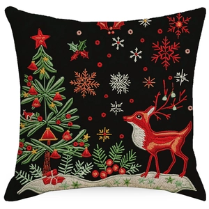 Detail of linen Christmas pillowcase showing red reindeer and tree embroidery texture