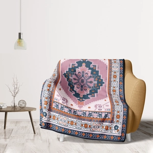 Detail of bohemian patterned throw blanket with intricate geometric weaves on a sofa