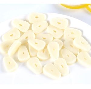 Macro shot of realistic PVC garlic slices for miniature food scenes on white plate