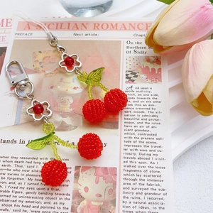 Handmade beaded cherry keychain with red crystals and green leaves on metal floral clasp