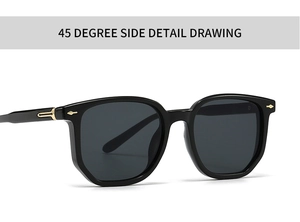 Detail view of square black sunglasses with golden metal hinges and gray lenses
