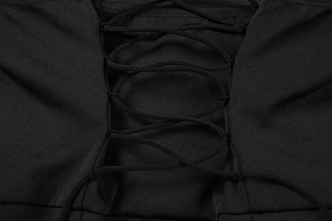 Detail of elegant black evening dress showing intricate lace-up back design and fabric texture