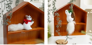 Detail of cute foam squirrel Christmas ornaments with red scarf and pine cones