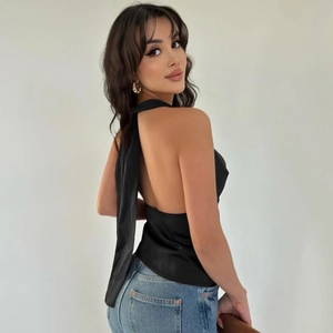 Detail of elegant black backless halter top with smooth satin texture and tie closure