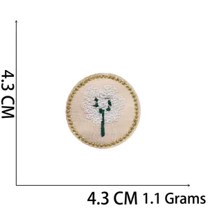 Round floral patch with pink base, white embroidery, gold border, and 4.3 cm size mark