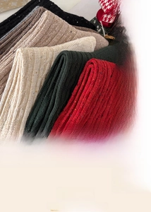 Macro shot of knitted cotton socks with textured rib pattern and festive color flecks