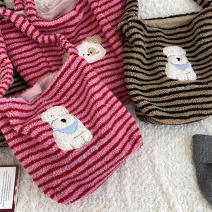 Detail of plush striped tote bags with cute cartoon dog embroidery and Happy Dog text