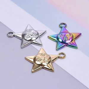 Macro view of pentagram star pendants with face relief in silver, gold and rainbow finish
