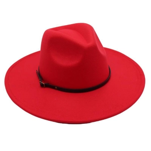 Close-up detail of a bright red wool fedora hat with a black leather belt buckle strap