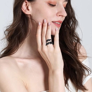 Detail of adjustable black feather ring showing intricate texture and vintage style