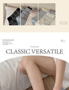 Detail of colorful striped combed cotton mid-calf socks with rolled edge and cozy texture