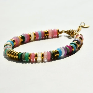Detailed shot of multi-color disc bead bracelet with gold spacers and lobster clasp
