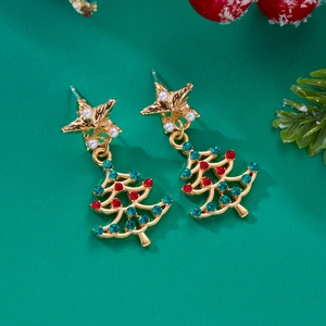 Detailed close-up of Christmas tree stud earrings with green rhinestones and pearls