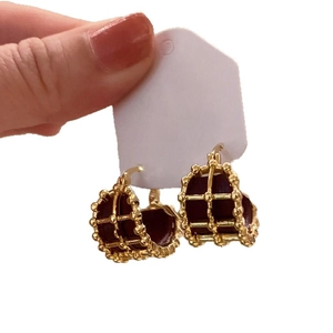 Vintage round gold-plated earrings with dark burgundy leather inlay in a woven metal frame