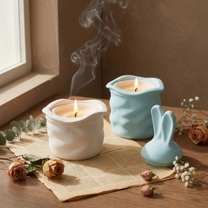 Detailed view of wave-textured ceramic candle jars with cute bunny ear lids for decor