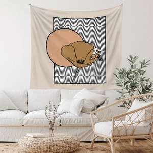 Detail view of bohemian wall tapestry with floral and bee design in a modern living room