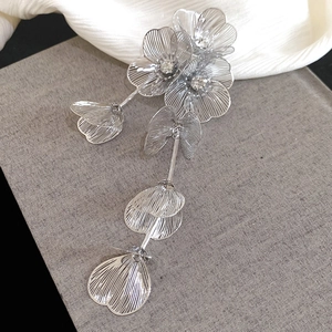 Detail of silver long tassel flower earrings featuring layered petals and sparkling rhinestones