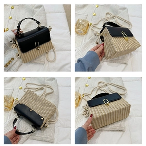 Detail of straw woven handbag with black leather flap, gold lock and rope strap