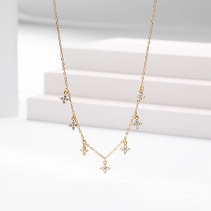 Detail of seven sparkling zircon floral pendants on a delicate gold clavicle chain