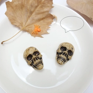 Macro view of two vintage skull decorations with black smoke finish for Halloween DIY