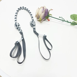 Detail of black and white houndstooth woven strap with a gray webbing and durable buckle
