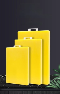 Three-piece yellow PE plastic cutting board set with handles for diverse kitchen tasks