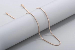 Detail view of a rose gold stainless steel snake chain with a secure lobster clasp closure