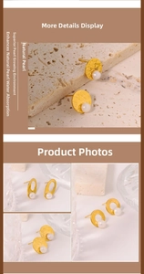 Detail view of natural pearl earrings with hammered gold metal and vintage aesthetic