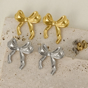 Minimalist 304 stainless steel bow earrings in gold and silver on a stone base