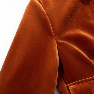 Detailed close-up showing the rich texture of caramel velvet fabric and seam stitching