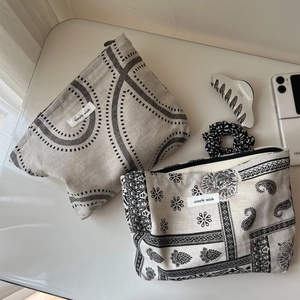 Detail of vintage paisley and geometric canvas pouches with simple wish label and zipper