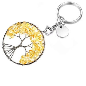 Detail of silver tree of life keychain featuring yellow crystal stones and wire-wrapped design