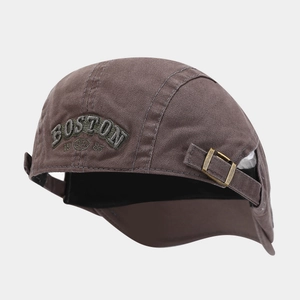 Detail of Boston 1985 embroidery on brown cotton cap with brass metal buckle