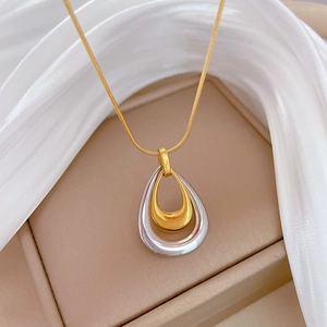 Dual-tone teardrop pendant necklace in gold and silver finish with sleek snake chain