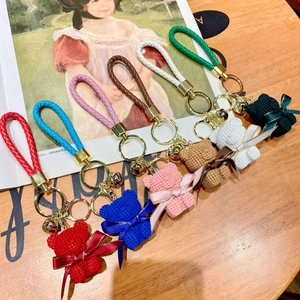 Colorful resin sitting bear keychains with textured strap and golden bell in seven colors
